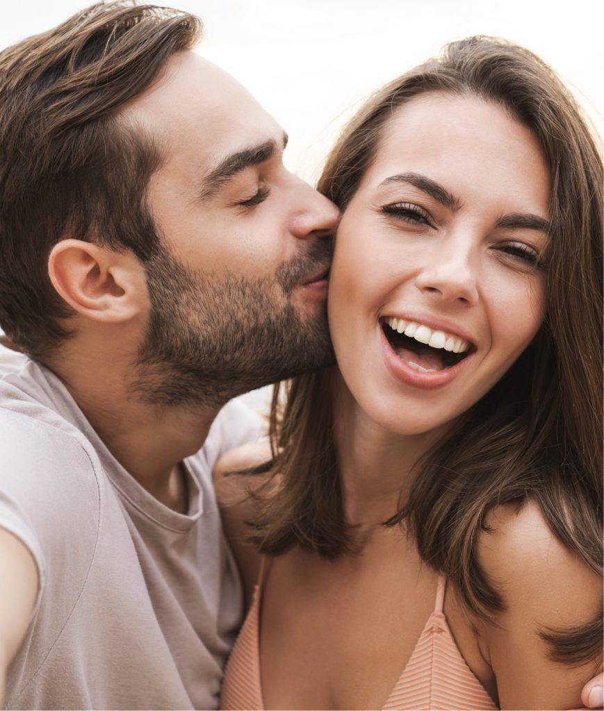 Boyfriend kissing his girlfriend on the cheek