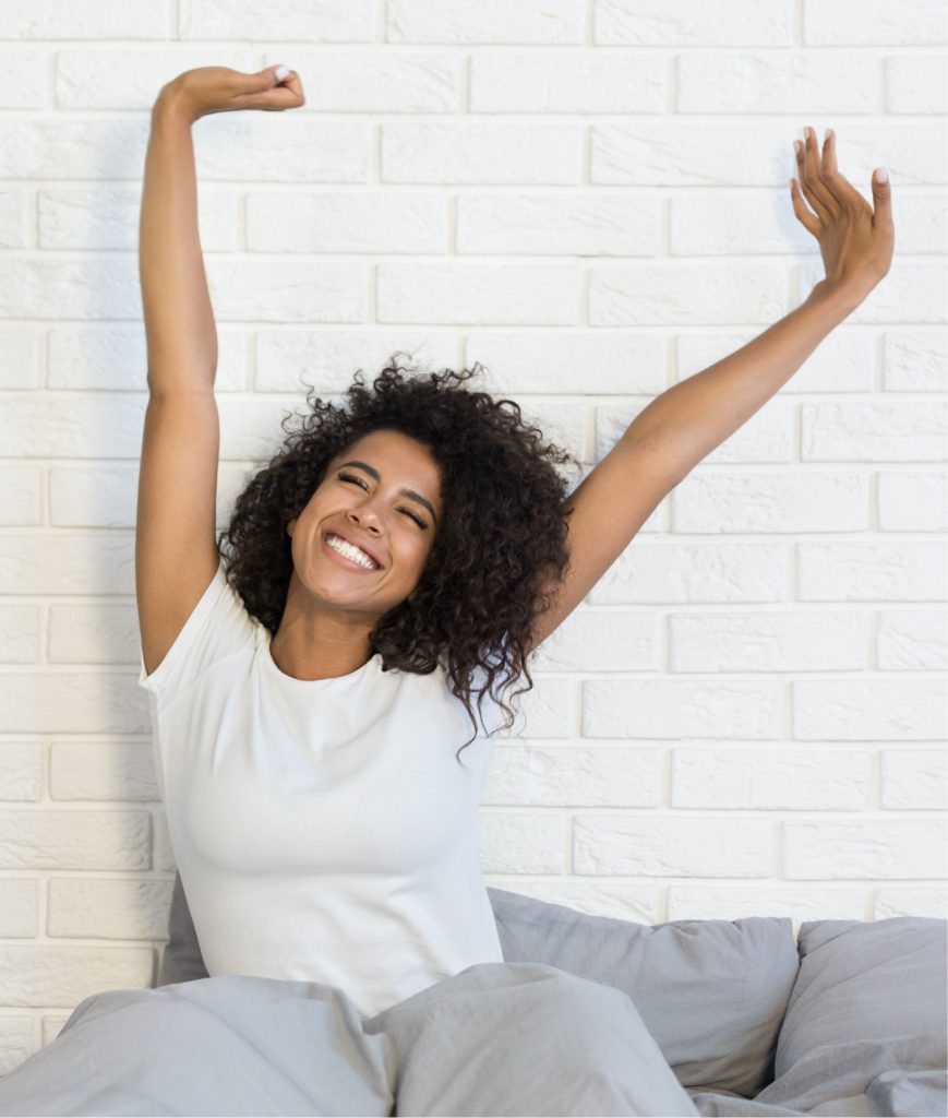 Woman stretching in bed