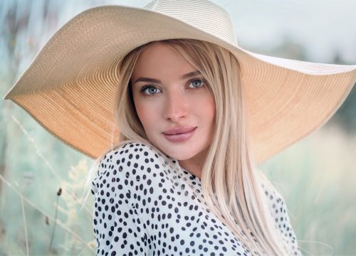 Woman wearing a hat outside after her GiGi Signature Facial